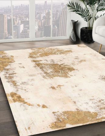 8' Square Ivory Gold Distressed Modern Abstract Area Rug angled close-up displaying the layered distressed effect and metallic-inspired gold tones.