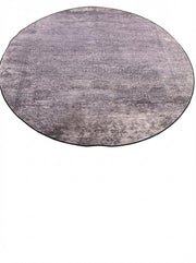 8' round taupe and light gray distressed abstract area rug featuring a soft textured pattern and subtle tonal variation for a modern look.
