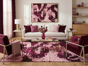 8' x 10' Blush Pink Burgundy Distressed Abstract Modern Washable Area Rug styled in a living room with a white sofa, burgundy accent chairs, and wooden coffee table.