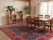 8' x 10' Navy Red Floral Persian Traditional Area Rug styled in a dining room with a wooden table, matching chairs, and large windows.