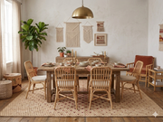 8' x 10' Rectangular Beige Red Polka Dot Contemporary Washable Area Rug styled in a bohemian dining room with a rustic wooden dining table, rattan chairs, woven wall decor, and brass pendant lighting.