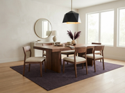 8' x 10' Rectangular Charcoal Gray Dark Gray Solid Textured Modern Minimalist Washable Area Rug styled in a dining room with a wooden table and upholstered chairs.