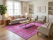 8' x 10' Rectangular Fuchsia Pink Lavender Distressed Floral Medallion Vintage Washable Area Rug styled in a living room with a beige sofa and wooden coffee table.