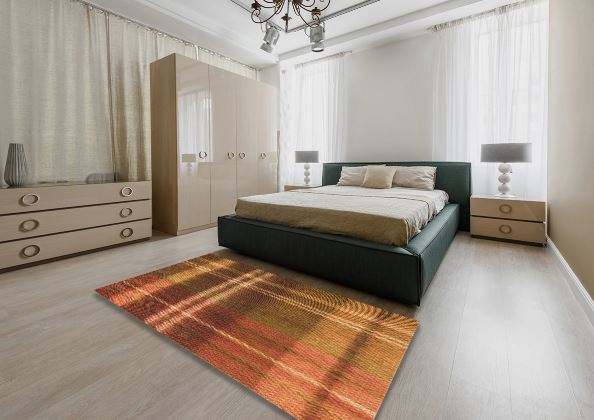 8' x 10' Tomato Red Brown Gold Patterned Rug staged in a modern bedroom setting, showcasing the bold crosshatch design and warm color palette.