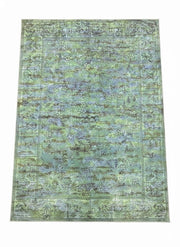 8' x 10' light olive and moss green vintage botanical area rug featuring a subtle floral pattern with softly distressed detailing and a classic border design.