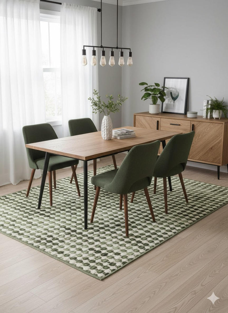 8' x 10' soft sage green and cream washable geometric dot area rug styled beneath a modern dining table with green upholstered chairs and natural wood furniture.