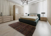 8' x 12' Dark Brown Machine Washable Traditional Area Rug placed in a bright bedroom with a dark upholstered bed, cream bedding, and modern furniture.