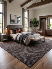 8' x 12' Rectangular Charcoal Black & Taupe Checkered Geometric Modern Washable Area Rug placed beneath a wooden bed with gray bedding and an upholstered bench.
