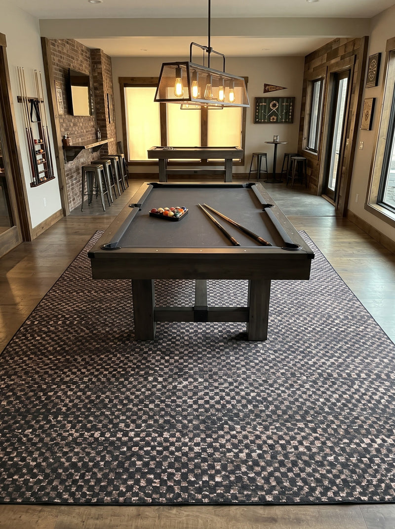 8' x 12' Rectangular Charcoal Black & Taupe Checkered Geometric Modern Washable Area Rug styled in a game room beneath a black pool table and industrial pendant lighting.