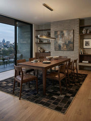 8' x 12' Rectangular Dark Brown Black Checkered Geometric Modern Area Rug styled in a modern dining room with a wooden table and brown chairs.