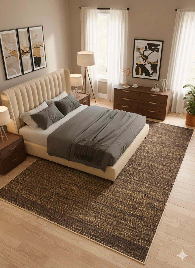 8' x 12' Rectangular Dark Brown & Gold Striped Textured Modern Washable Area Rug placed beneath a cream upholstered bed with gray bedding and wooden nightstands.