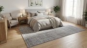 8' x 12' Rectangular Gray Charcoal Textured Grid Geometric Modern Washable Area Rug placed in a cozy bedroom with a gray upholstered bed, neutral bedding, and wooden furniture.