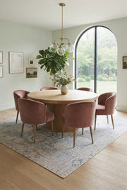 8' x 12' Rectangular Ivory Light Blue Distressed Tribal Vintage Washable Area Rug styled in a bright dining room with a round wooden table and pink chairs.