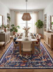 8' x 12' Rectangular Navy Blue Multicolor Pictorial Hunting Scene Traditional Oriental Area Rug styled in a traditional dining room with a wooden table and upholstered chairs.