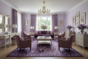8' x 12' Rectangular Purple Lavender Floral Botanical Mosaic Modern Washable Area Rug styled in an elegant living room with a purple sofa, lavender accent chairs, white coffee table, crystal chandelier, and floral wall decor.
