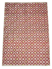 8' x 12' Rectangular Red & Ivory Diamond Geometric Modern Washable Area Rug styled in a modern living room.