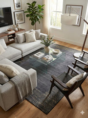 8' x 12' charcoal and warm taupe distressed modern washable area rug placed in a contemporary living room with neutral seating, a glass coffee table, and warm wood accents.