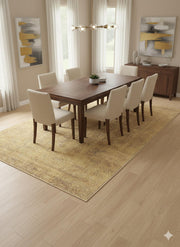 8' x 12' golden tan distressed traditional washable area rug styled beneath a wooden dining table with upholstered chairs in a bright dining space.