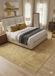 8' x 12' golden tan vintage distressed washable area rug placed under a neutral upholstered bed with warm brown and beige accents.