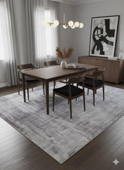 8' x 12' gray and ivory abstract area rug styled beneath a mid-century modern dining table with wood chairs and minimalist lighting.