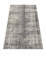 8' x 12' gray and ivory distressed abstract area rug featuring soft tonal variation with light silver and charcoal accents for a modern textured look.
