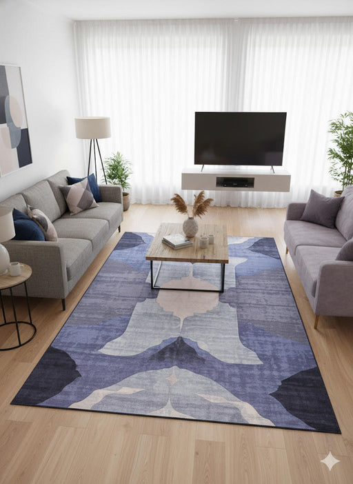 8' x 12' purple gray abstract modern washable area rug styled in a minimalist living room with sofas, a coffee table, and a mounted TV.