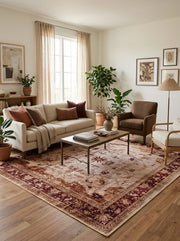 8' x 8' Square Beige & Burgundy Distressed Floral Border Vintage Traditional Area Rug styled in a living room with a cream sofa and brown accent chair.