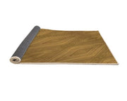 8' x 8' Square Dark Bisque Brown Diamond Pattern Area Rug rolled corner view revealing the flexible backing and neatly finished edges.