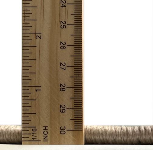 8' x 8' Square Dark Bisque Brown Diamond Pattern Area Rug thickness measurement view showing the low-profile pile height next to a ruler for scale.