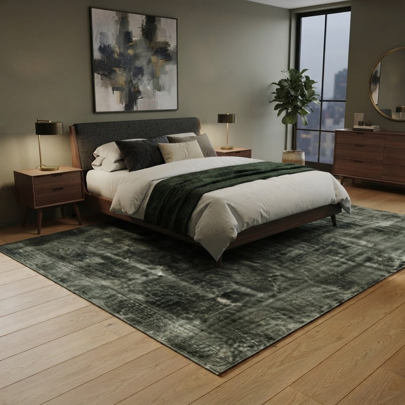 8' x 8' Square Dark Green & Gray Distressed Vintage Washable Area Rug placed in a bedroom beneath a wooden bed with white bedding and a dark green throw blanket.