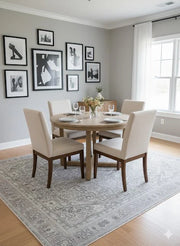 8' x 8' Square Gray & Ivory, Light Beige Medallion Traditional Area Rug placed in a dining room with a round wooden dining table and four cream upholstered chairs.