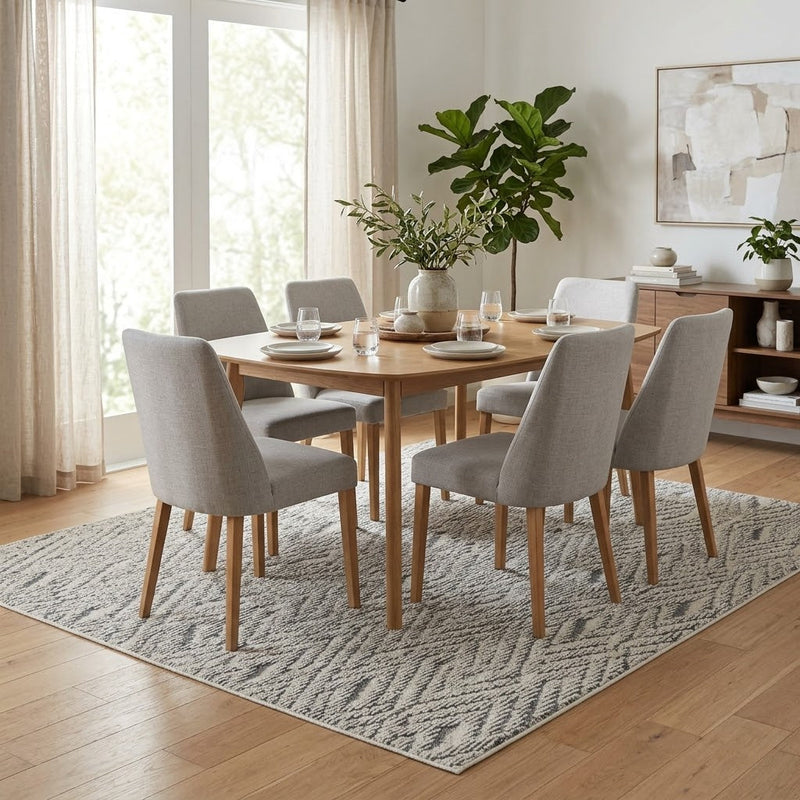 8' x 8' Square Ivory & Gray Tribal Geometric Modern Washable Area Rug styled in a dining room beneath a wooden table and beige upholstered chairs.