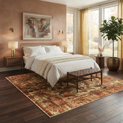 8' x 8' Square Rust & Gold Distressed Floral Medallion Vintage Washable Area Rug placed in a bedroom beneath a bed with white bedding and a wooden bench.