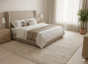 8' x 8' square beige and ivory minimalist rug placed under a bed in a bright bedroom with neutral bedding and soft natural textures.