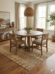 8' x 8' square beige brown distressed modern rustic washable area rug styled beneath a round wood dining table with upholstered chairs in a bright dining space.