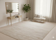 8' x 8' square beige textured area rug styled in a minimalist space with a wooden console table, bench seating, and light neutral décor.