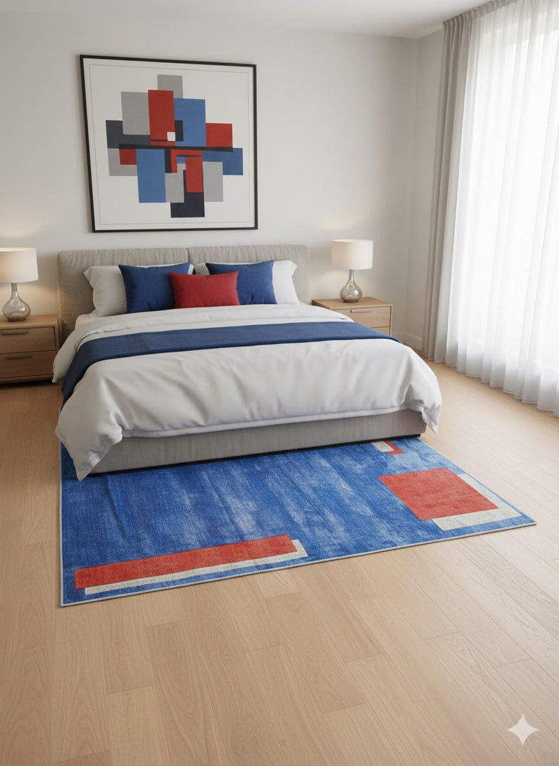 8' x 8' square blue geometric contemporary area rug with rust and beige accents styled under a modern bed with neutral bedding and bold abstract wall art.