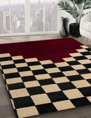 Angled close-up view of the 6' x 9' Abstract Dark Almond Brown Modern Area Rug highlighting the bold checkerboard pattern, contrasting deep red abstract section, and textured contemporary design.
