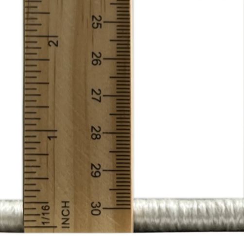 Close-up measurement image showing the 2' x 3' ivory and gold distressed abstract accent rug low-profile pile thickness using a ruler.
