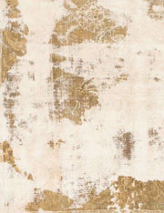 Detailed view of the rug showing a distressed abstract pattern in soft ivory with warm gold accents.
