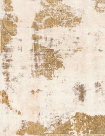 Detailed view of the rug showing a distressed abstract pattern in soft ivory with warm gold accents.