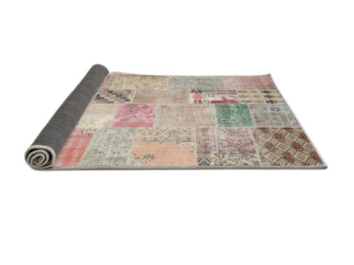 Side view of the rug partially rolled to show the backing and construction.